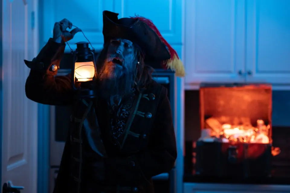 Pirate performer holding a lantern on the Geico Kitchen Island set