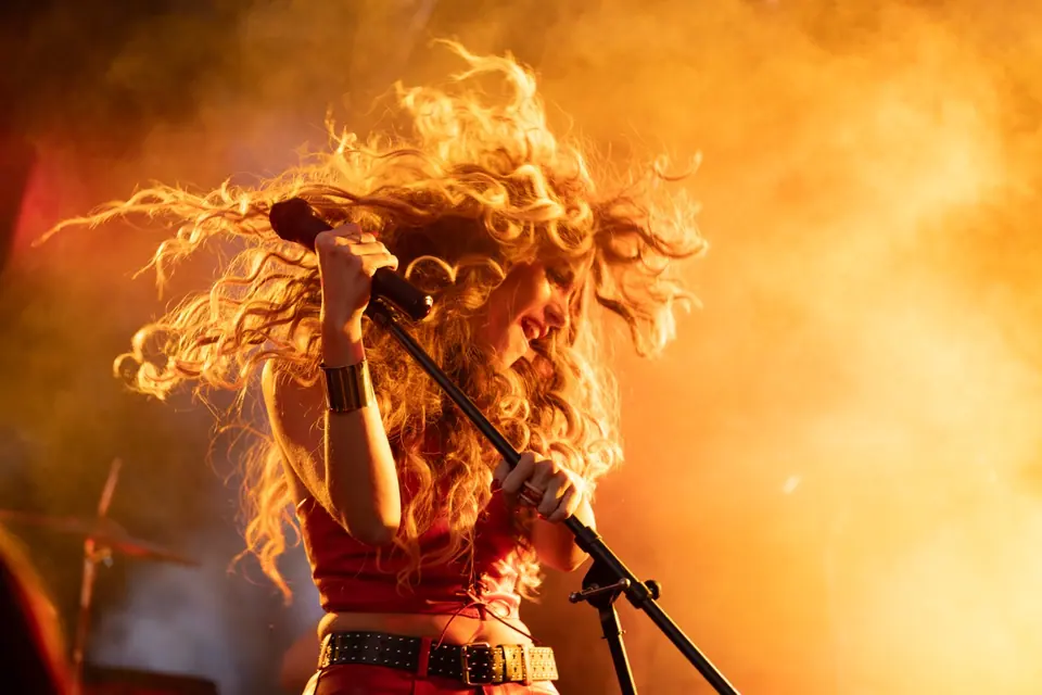 Singer performing under fiery stage lighting for the Bar-S Guy campaign