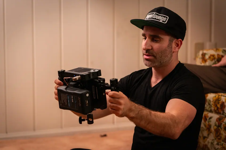 Ben Giroux checking a cinema camera between takes