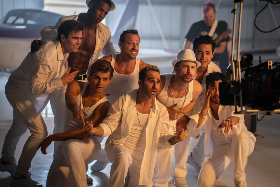 Baby Got Buns performers crowding around the cinema camera during a take