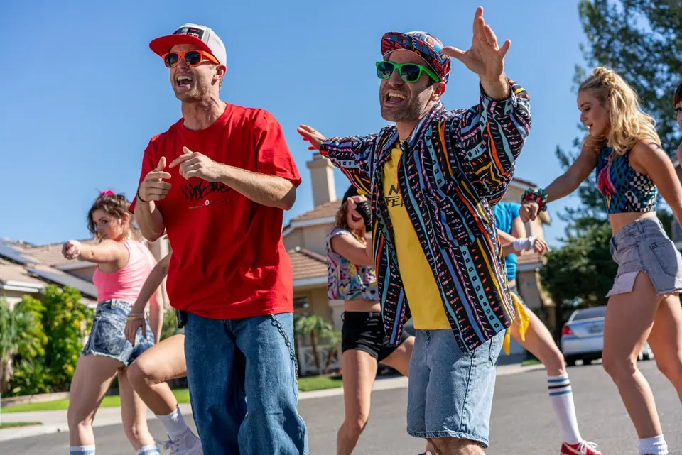 Ben Giroux and a performer leading dancers during an outdoor music-video shoot