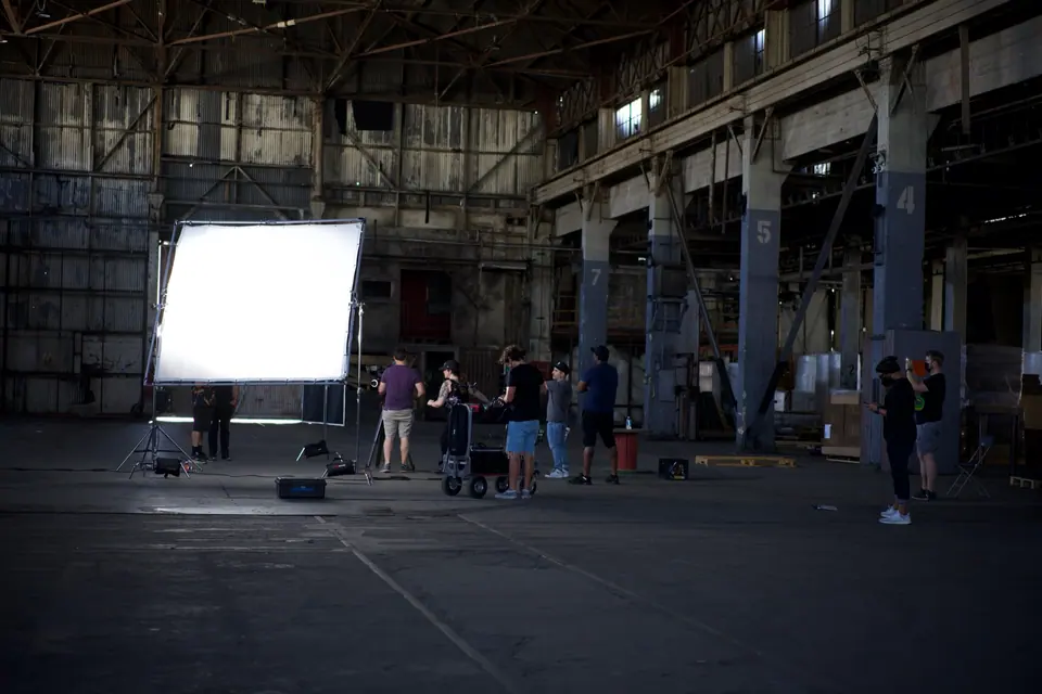 A production crew and large diffusion frame on the Realtor.com Were-House stage