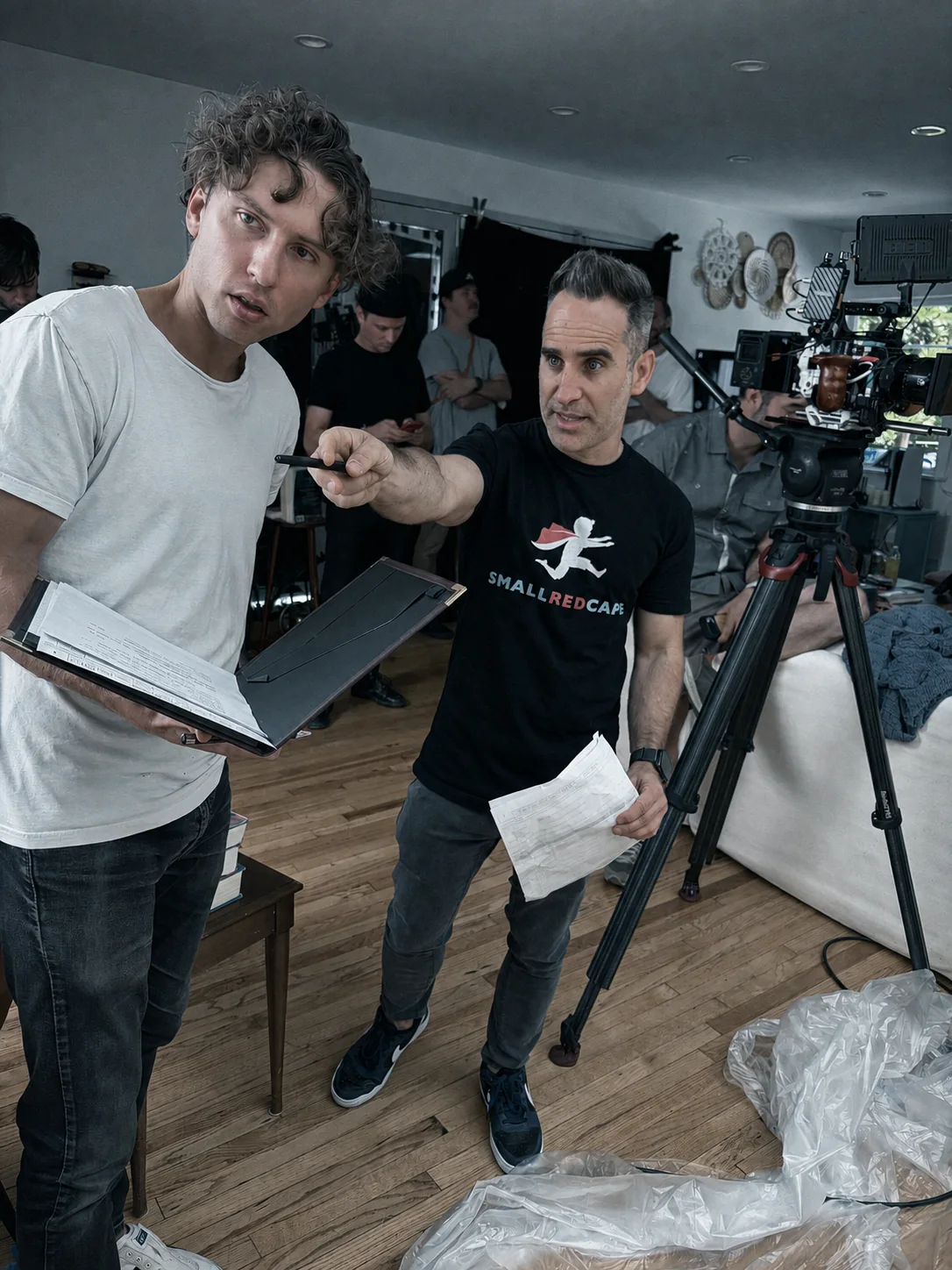 Ben Giroux directing beside the camera while working through a shot with a performer and crew